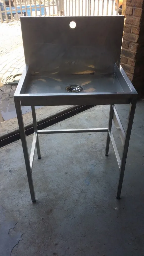 Free-standing stainless steel hand-wash basin with splashback
